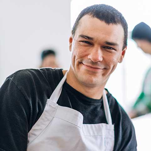 Smiling man wearing apron