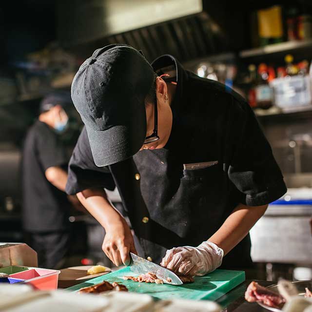 image showing person cutting food