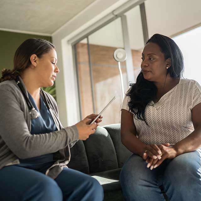 transitional two women seated on couch